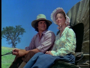 Charles and Caroline Ingalls in covered wagon in "Little House on the Prairie"